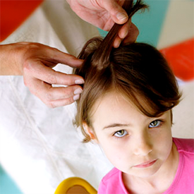 Girl getting checked for head lice - Lice Clinics of America Long Island